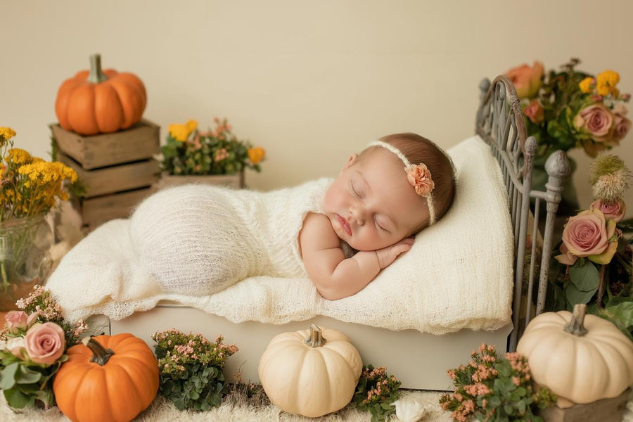 newborn baby girl in autumn pumpkin halloween scene, digital backdrop for photography