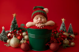 baby in christmas outfit on red backdrop, holiday newborn portrait, festive photo prop, studio scene, christmas baby photo