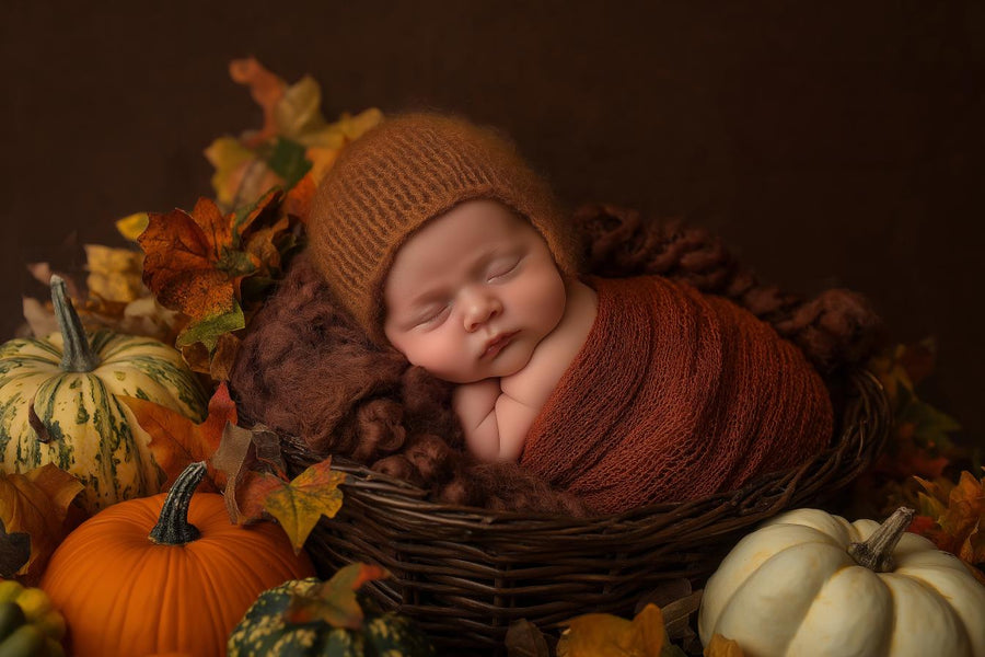 newborn baby in pumpkin-themed digital backdrop, autumn harvest scene, perfect for seasonal photos