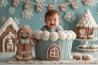 newborn baby surrounded by gingerbread cookies and winter wonderland decor