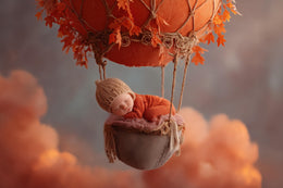 baby with hot air balloon and clouds in fall backdrop, perfect for newborn photos