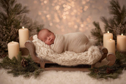 newborn baby on wooden bed in cozy christmas scene, holiday backdrop for festive photos