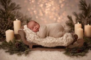 newborn baby on wooden bed in cozy christmas scene, holiday backdrop for festive photos